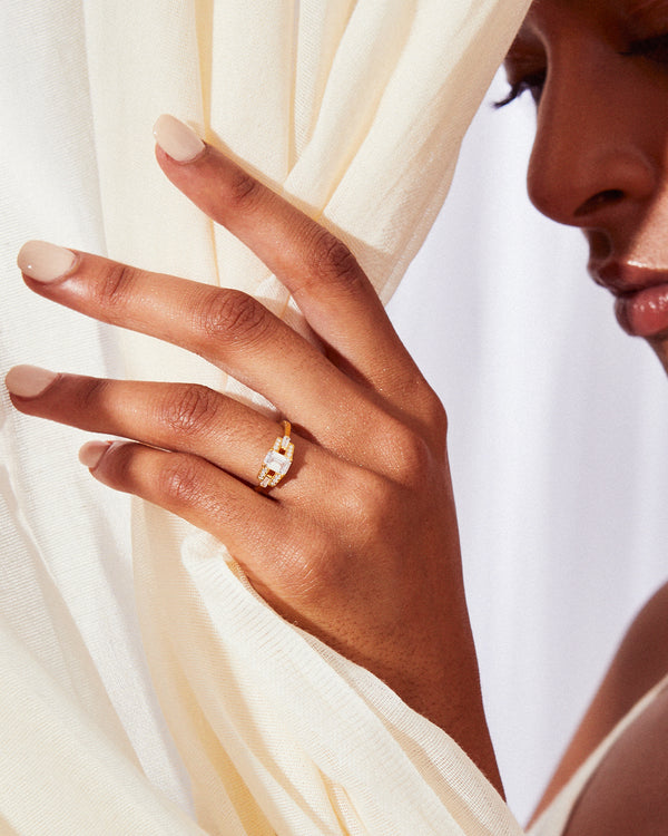 Emerald cut diamond buckle ring in platinum