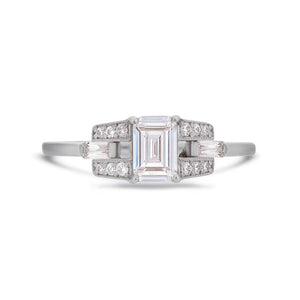 Emerald cut diamond buckle ring in platinum