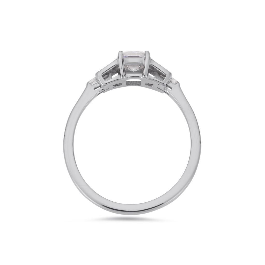 Emerald cut diamond buckle ring in platinum
