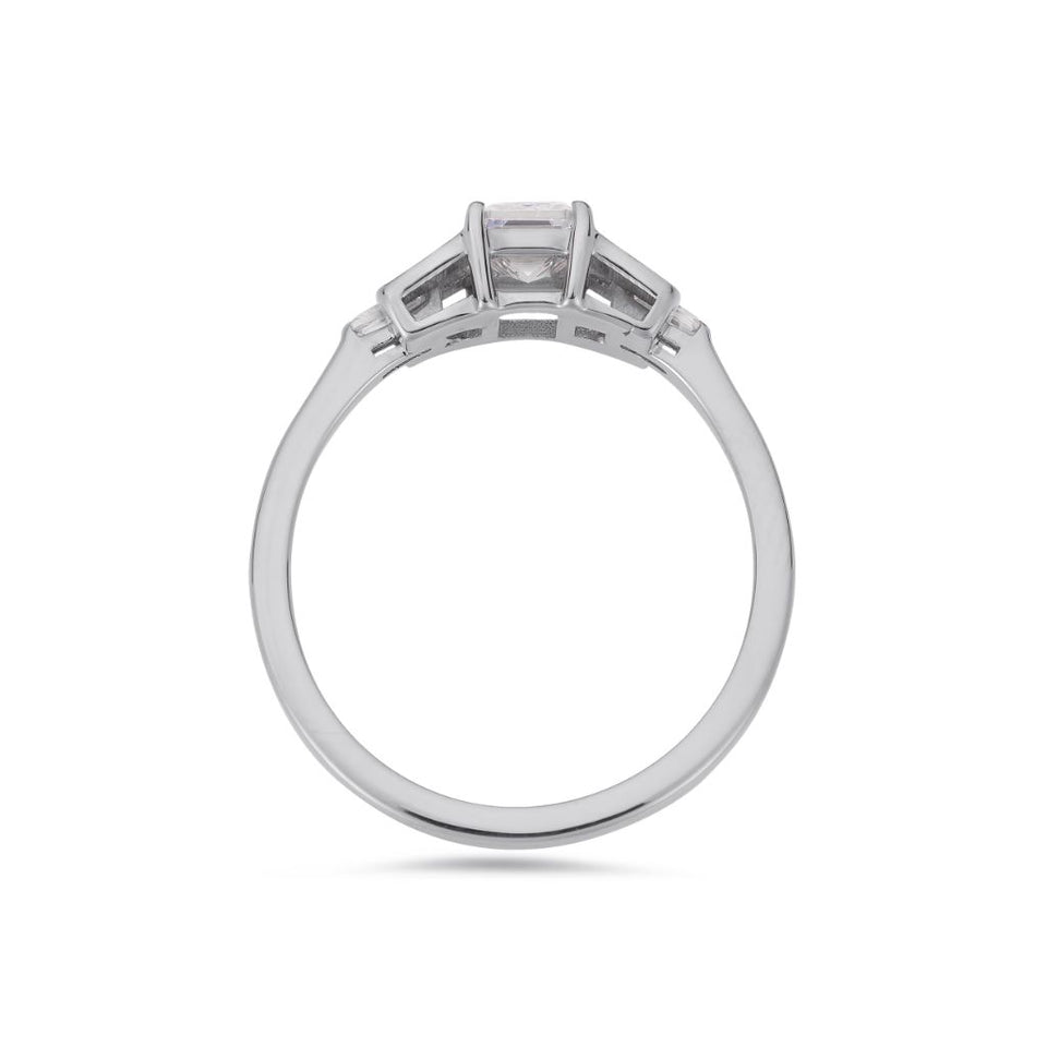 Emerald cut diamond buckle ring in platinum
